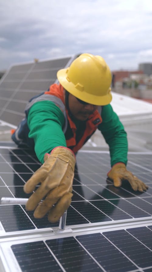 Man With Helmet Installing Solar Panels