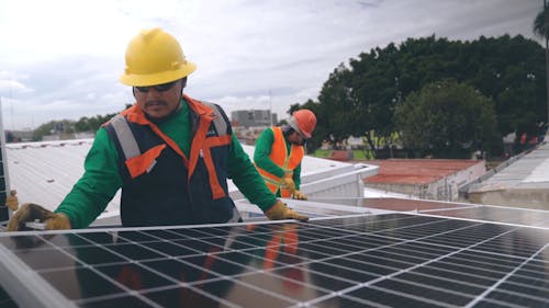 Man Safely Checking The Installation Of Solar Panels