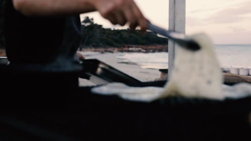 Man Cooking Using Tongs 