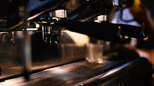 A Close Up Video of a Coffee Maker and Disposable Cup