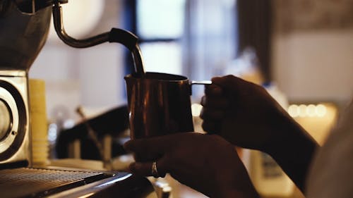 A Woman using a Coffee Maker