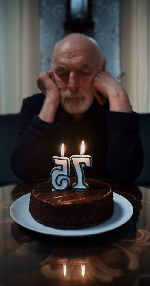 Man Blowing His Cake