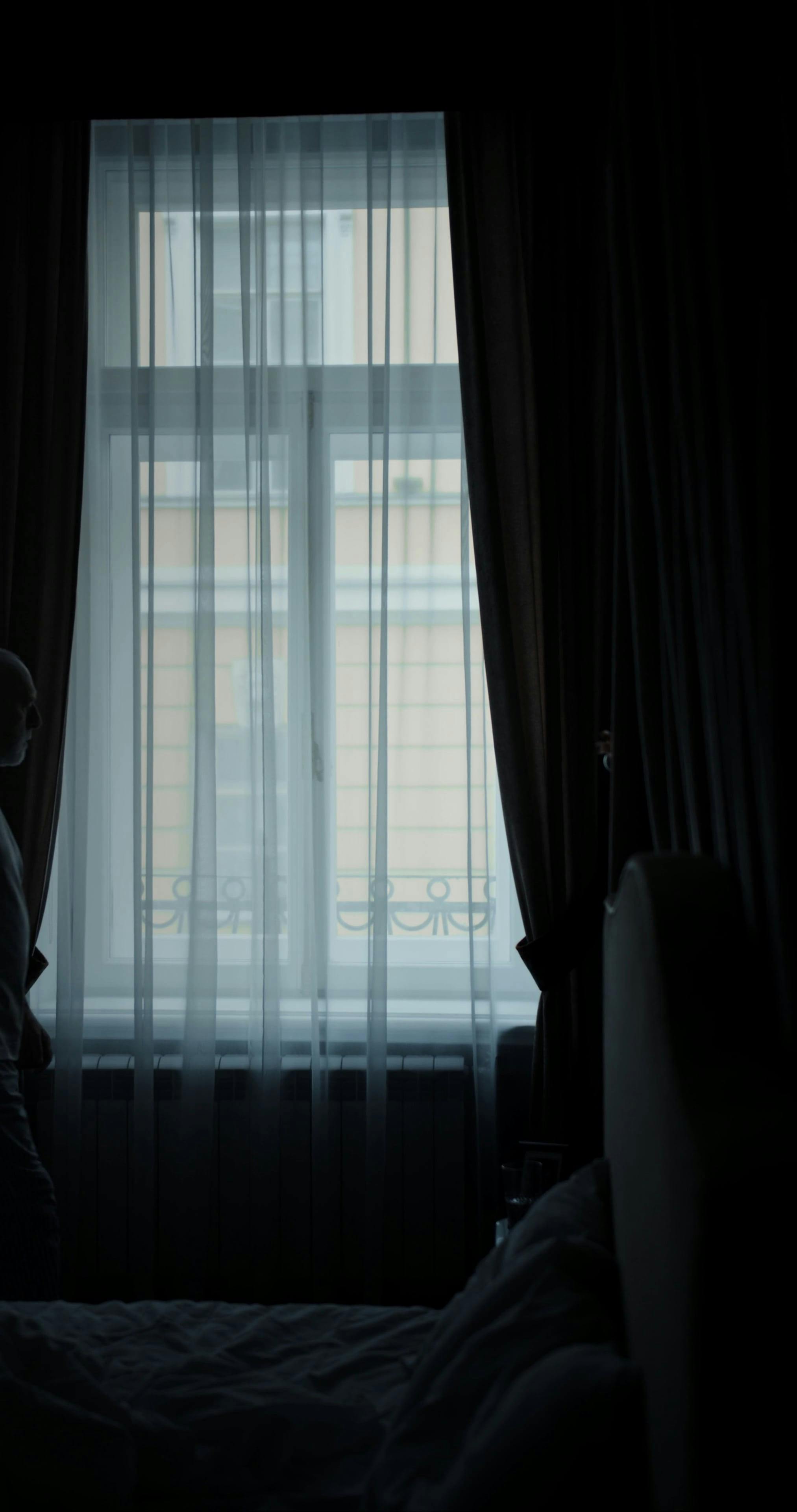 A Silhouette of a Man Looking Outside the Window · Free Stock Video