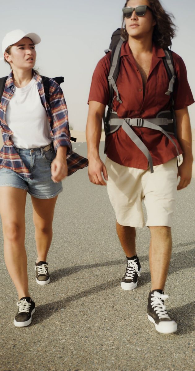 a young couple walking on a desert road 8865246