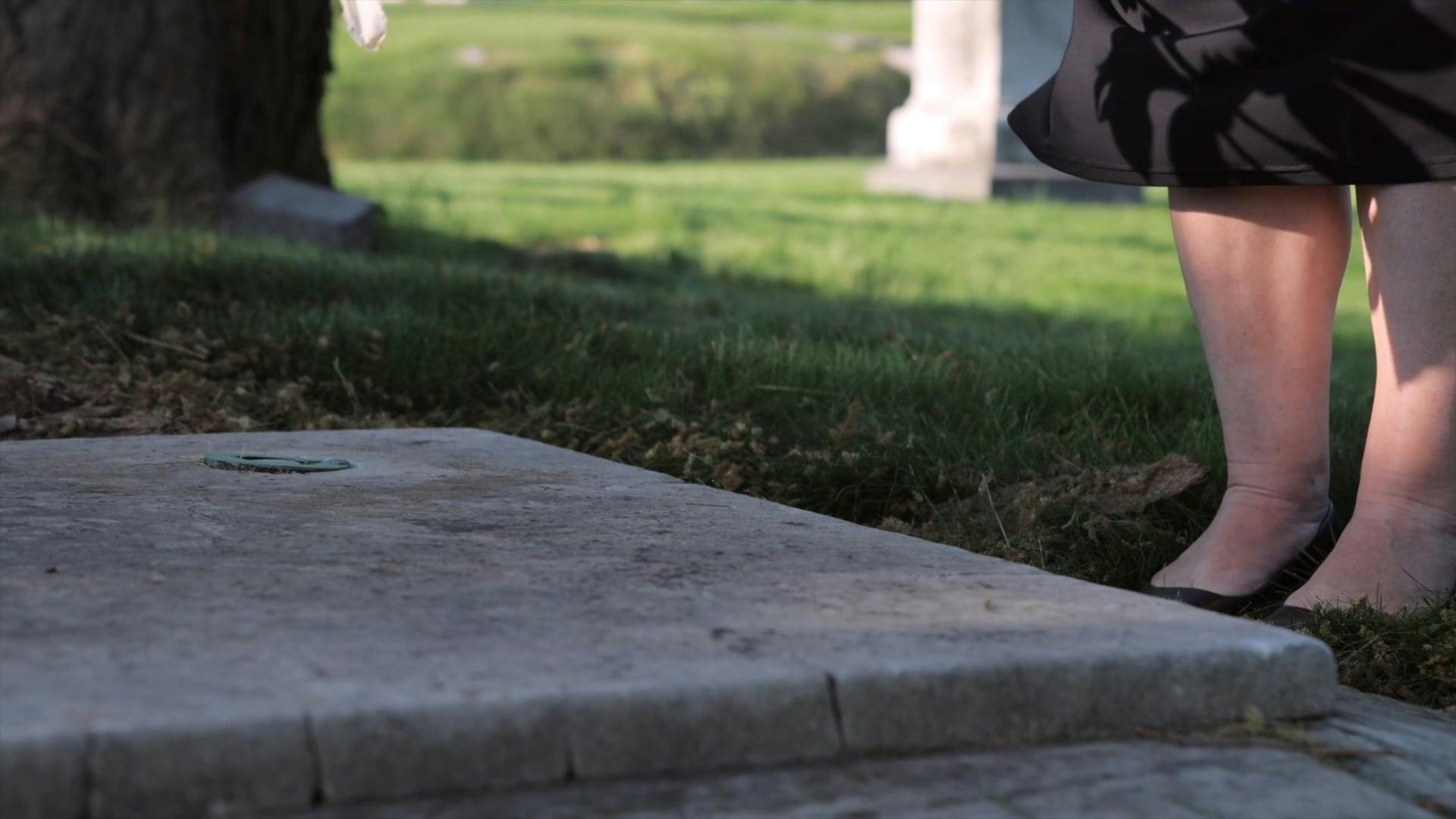 Peron Putting Flowers on a Grave in the Cemetery Free Stock Video
