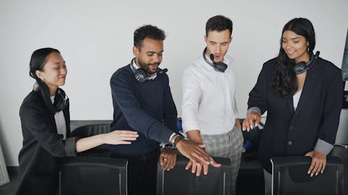 Call Center Agents Stacking Hands in an Office