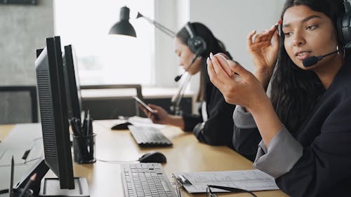 A Female Call Center Agent Doing her Makeup at Work