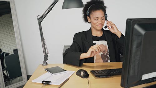 A Female Call Center Agent Typing on a Computer 