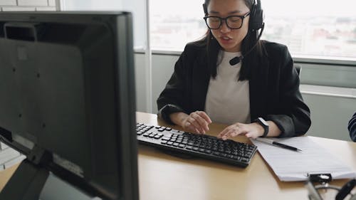 A Woman Typing While Talking 