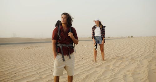 A Man and Woman Standing on the Desert