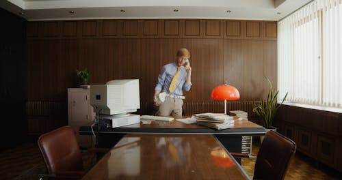 An Angry Man Talking on the Telephone