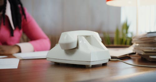 A Female Person Answering a Telephone