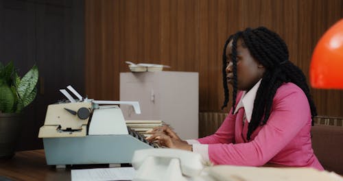 A Woman Using Vintage Typewriter