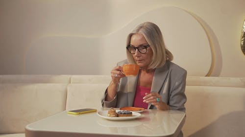 A Businesswoman Answering a Call at a Cafe