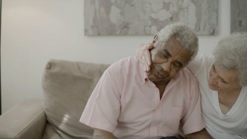 Elderly Woman Comforting an Elderly Man