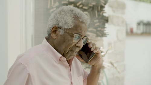 Elderly Man Crying While on a Phone Call