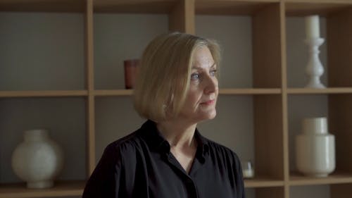 A Woman Putting on Eyeglasses