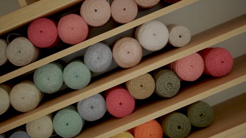 Rolling Shot Rolls of Yarn on Shelves