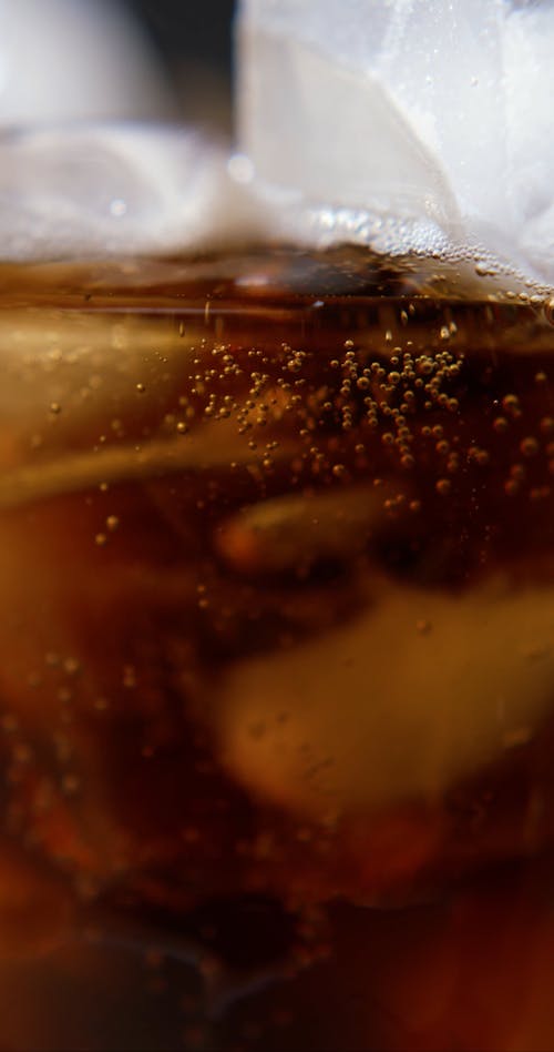 Pouring Cola in a Glass with Ice