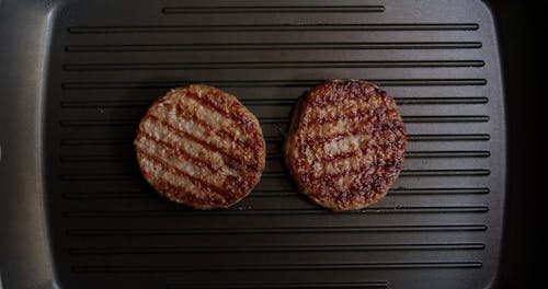 A Person Cooking Cheeseburger
