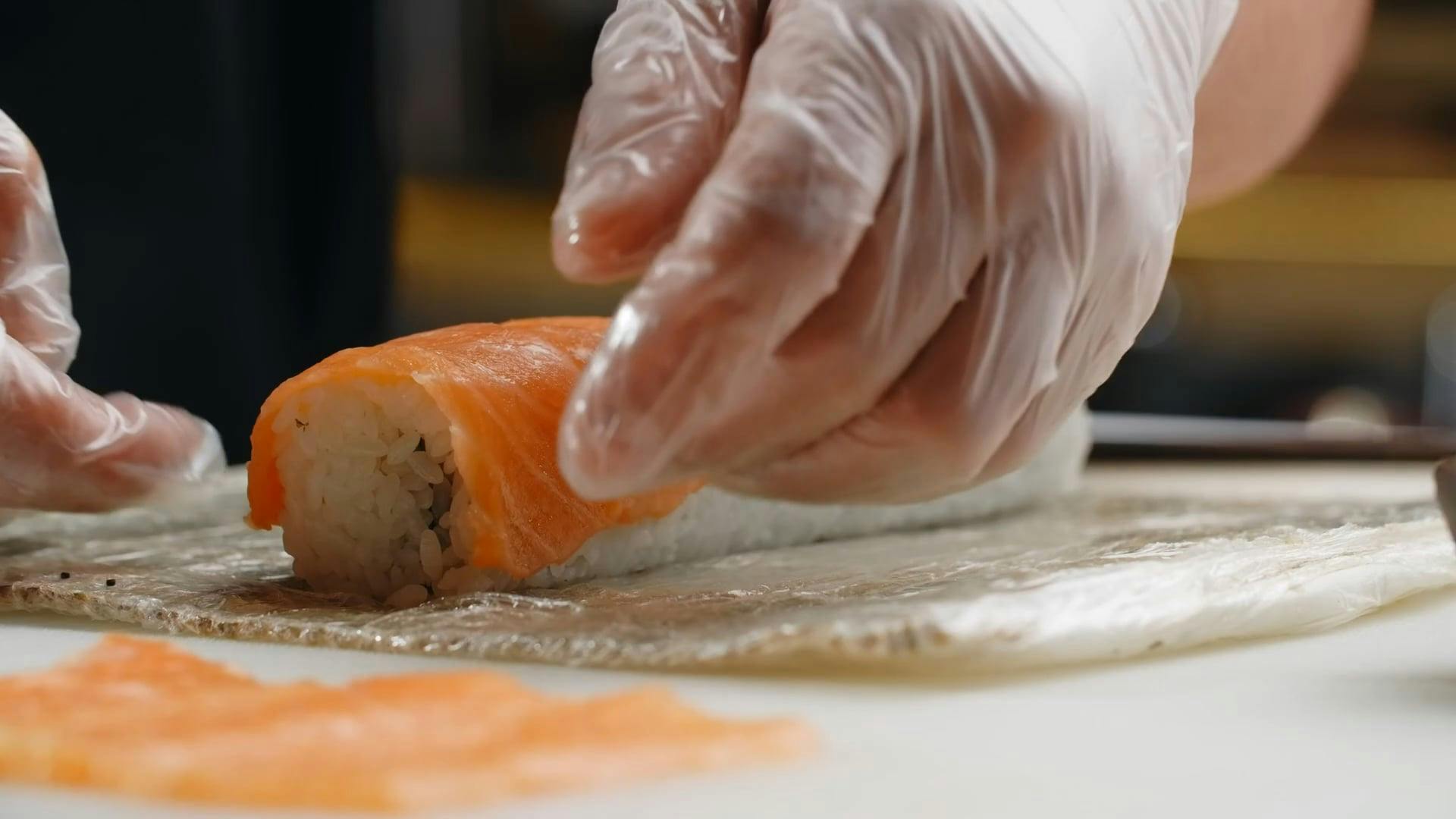 A Chef Placing Salmon Slices on Sushi Rice · Free Stock Video