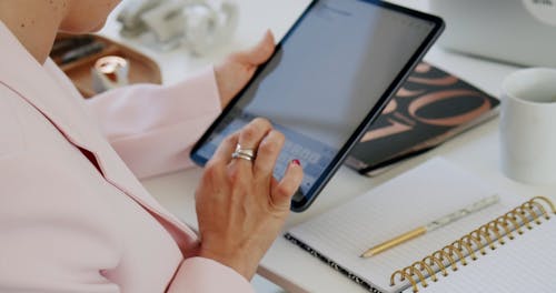 A Woman Using a Tablet at an Office