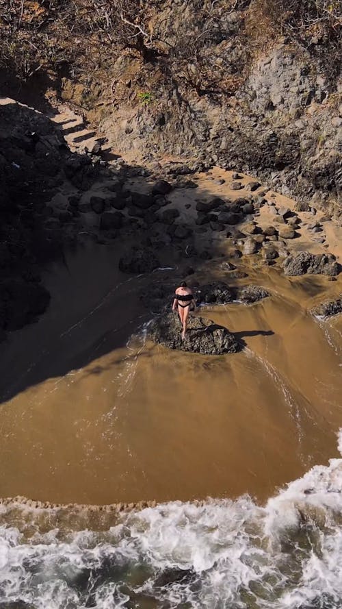 Aerial Shot of a Woman Entering the Sea