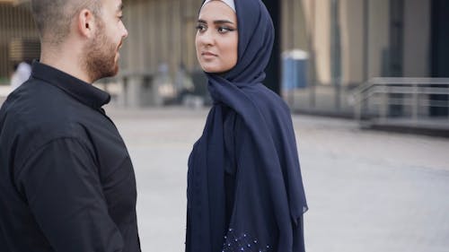 Man Talking to a Woman Wearing Hijab