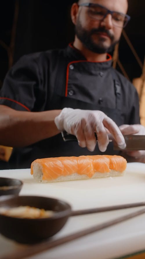 A Chef Cutting Sushi Rolls