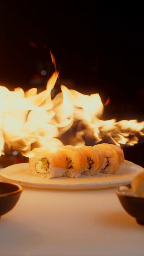 A Blazing Fire over Sushi Rolls