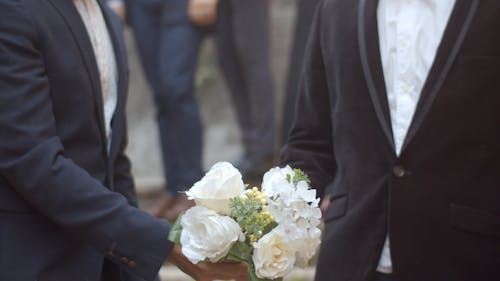A Couple Throwing their Wedding Bouquet