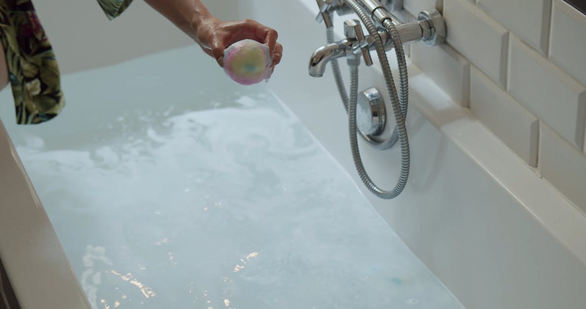 A Person Dropping A Bath Bomb In A Bathtub Free Stock Video Footage
