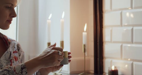 Woman Lighting a Candle