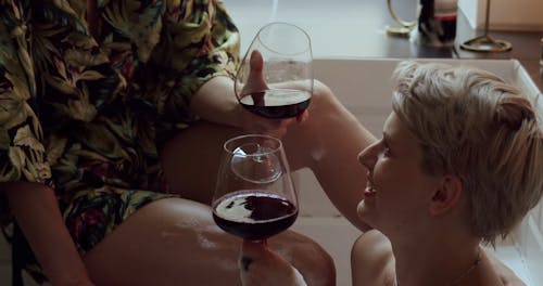 A Couple Drinking Wine while Taking a Bubble Bath