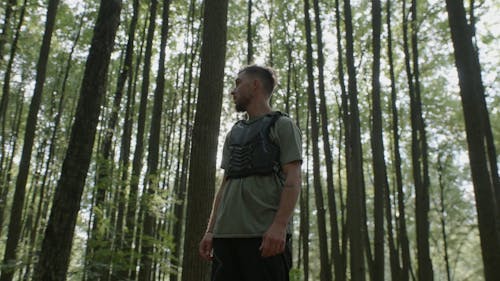 A Man in a Chest Protector Standing in the Woods