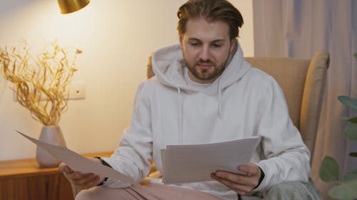 A Man Looking at Papers 