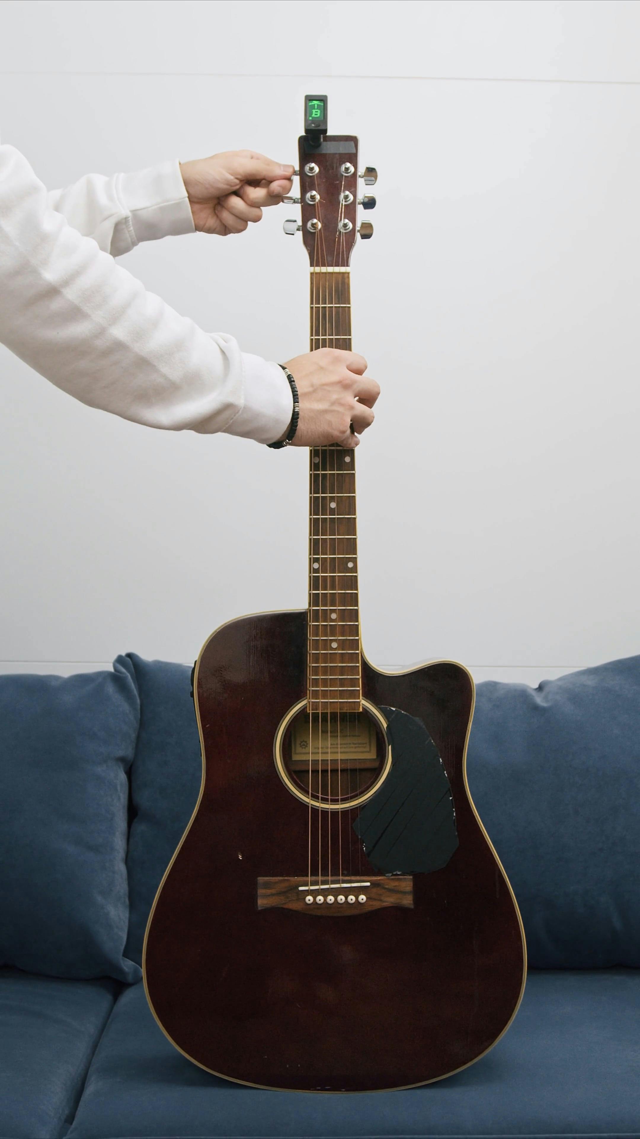 A Person Tuning an Acoustic Guitar · Free Stock Video