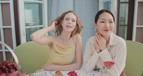 Women Having Conversation while Eating Fruits