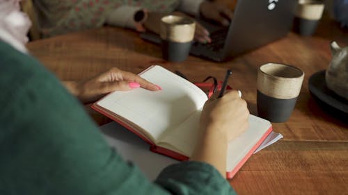 A Woman Writing in a Notebook