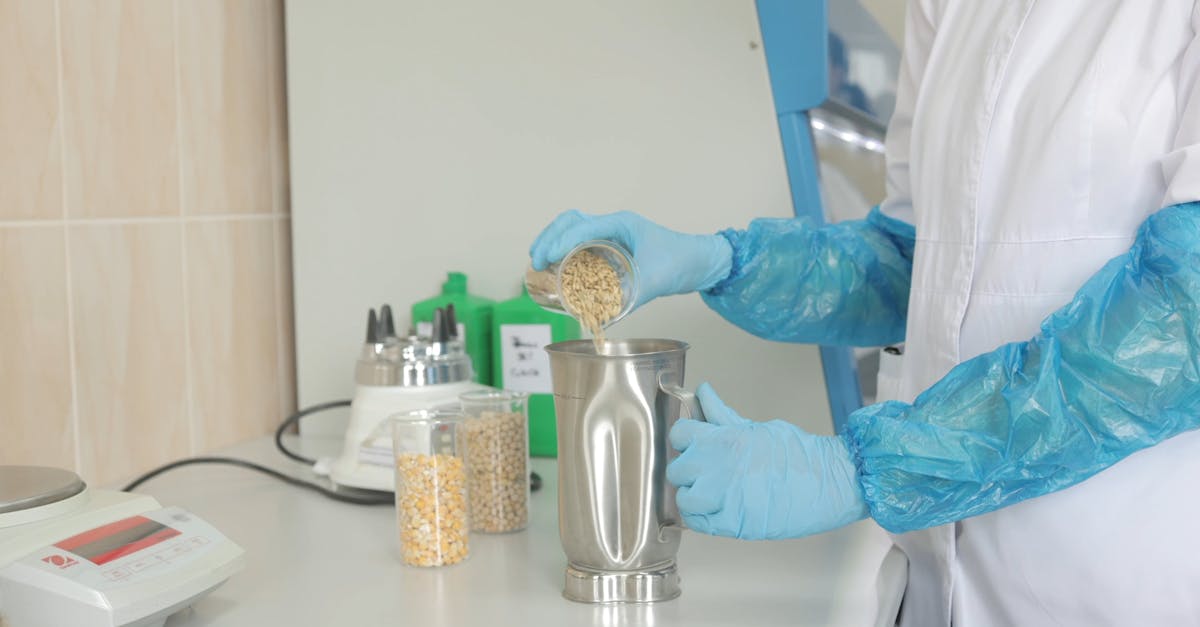 A Scientist Pouring Raw Rice on a Stainless Beaker Free Stock Video ...