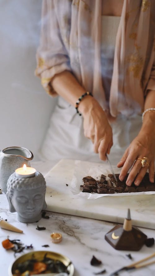 A Woman Cutting a Bar of Chocolate