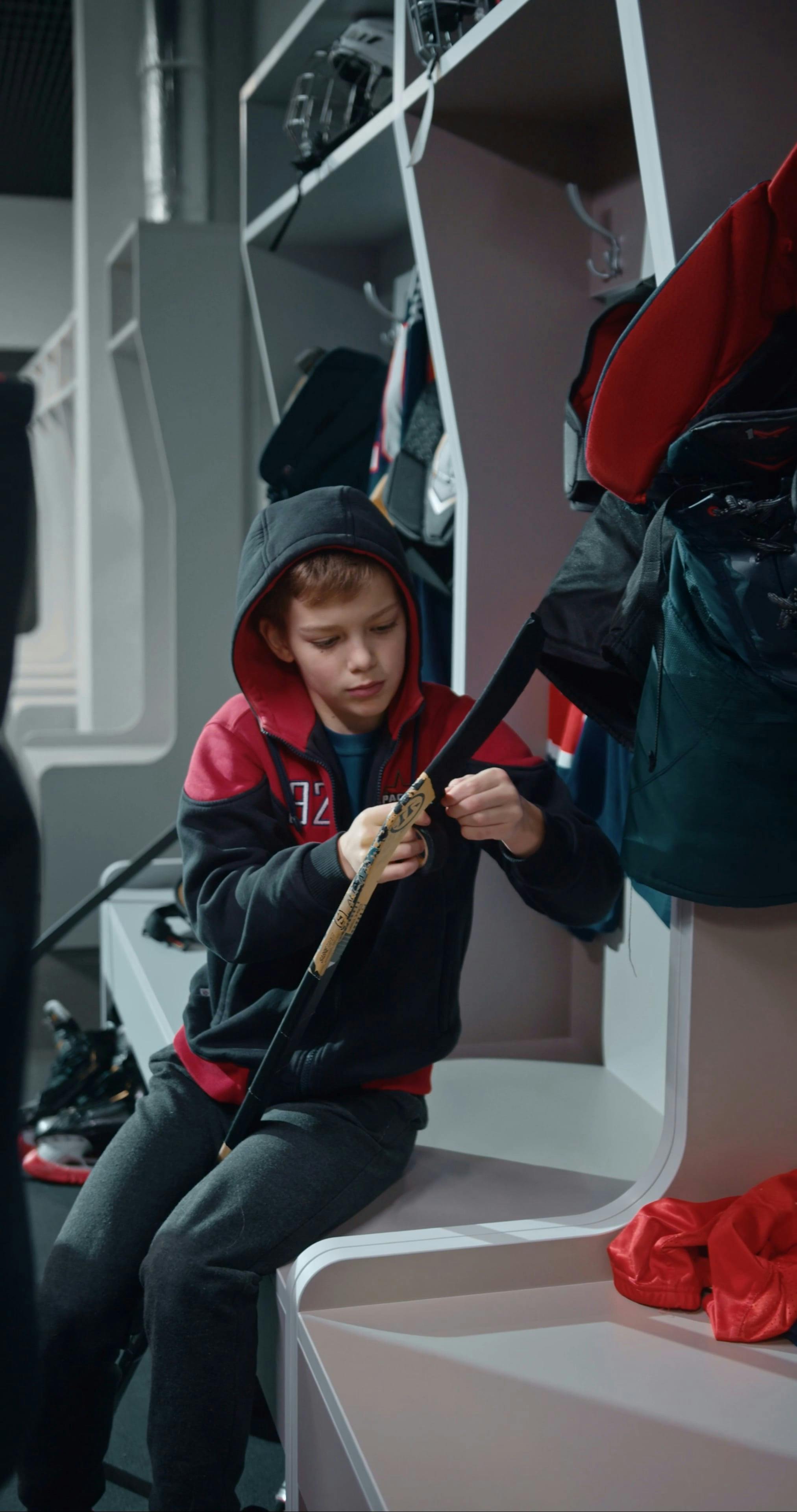 A Boy Putting Tape on his Hockey Stick Free Stock Video Footage, RoyaltyFree 4K & HD Video Clip
