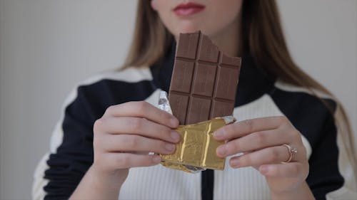 Woman Holding a Chocolate Bar