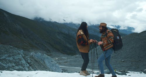 Man Carrying Backpack Kissing a Woman