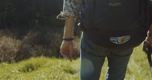 A Person Walking while Carrying a Backpack