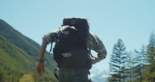 A Person Running while Carrying His Backpack