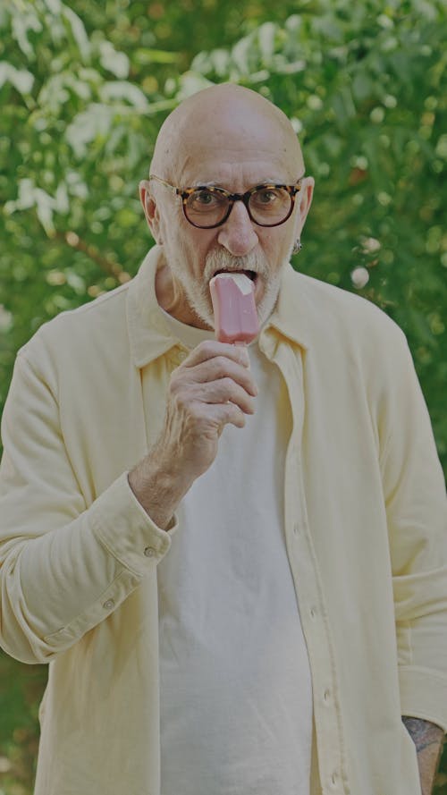 An Elderly Man Eating Popsicle