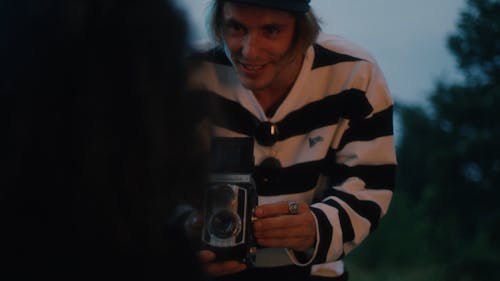 A Man Holding an Old Video Recorder