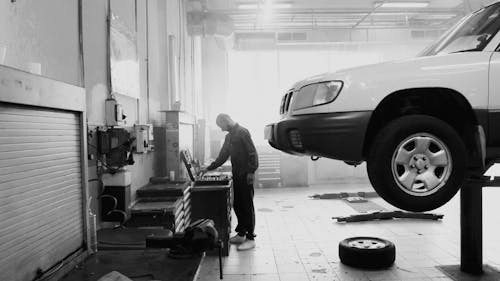 Man at the Garage Looking at a Toolbox