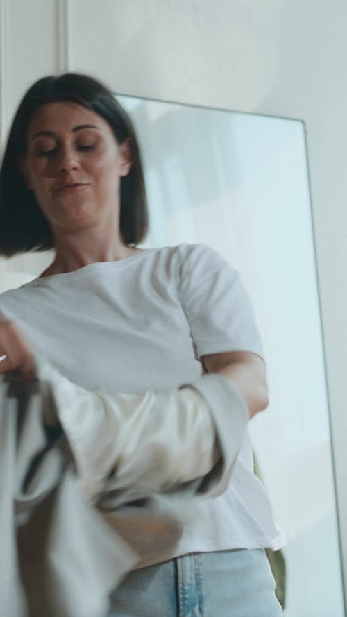 A Woman Putting On a Blazer 